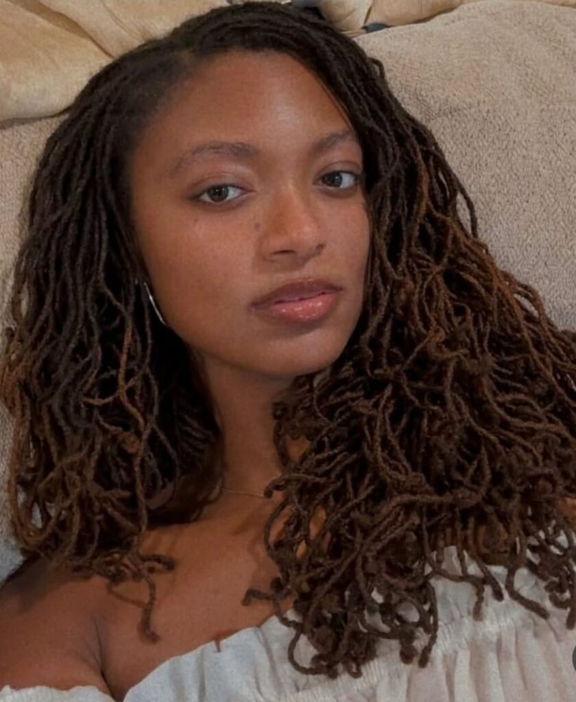Woman with long curly sister locs