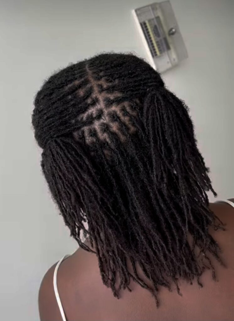 Woman on two side protective locs hairstyle