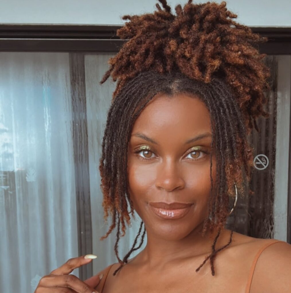 Woman on half up, half down brown locs hairstyle
