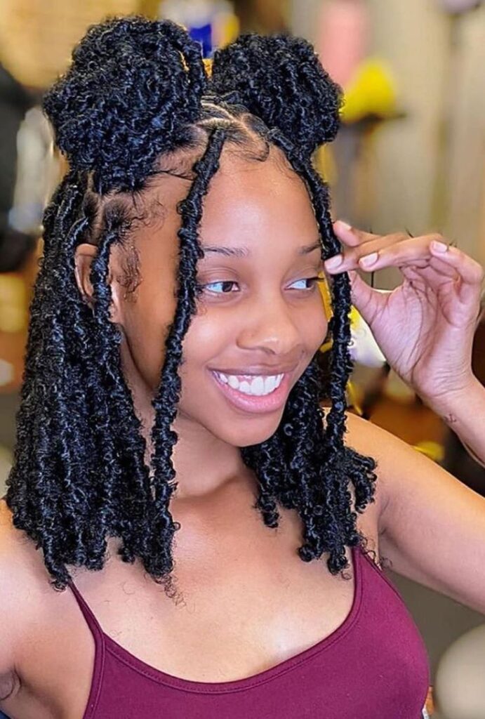 Woman on two bun styled braid locs