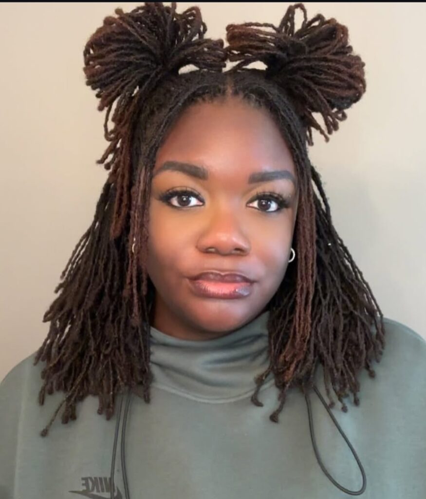 Woman on double buns locs hairstyle
