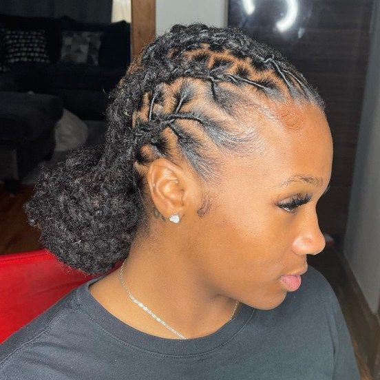 Woman on low bun  neatly styled locs