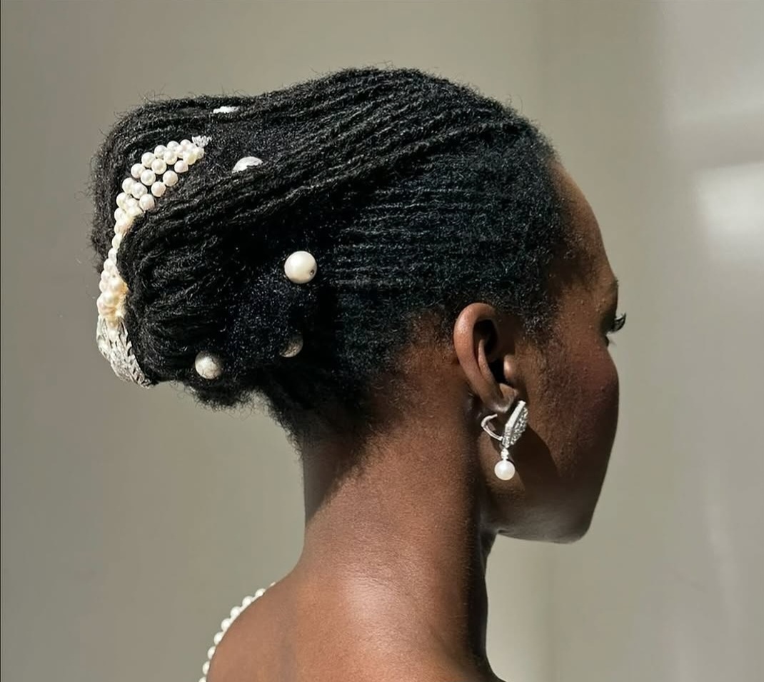 Neatly styles locs adorned with beads and petals