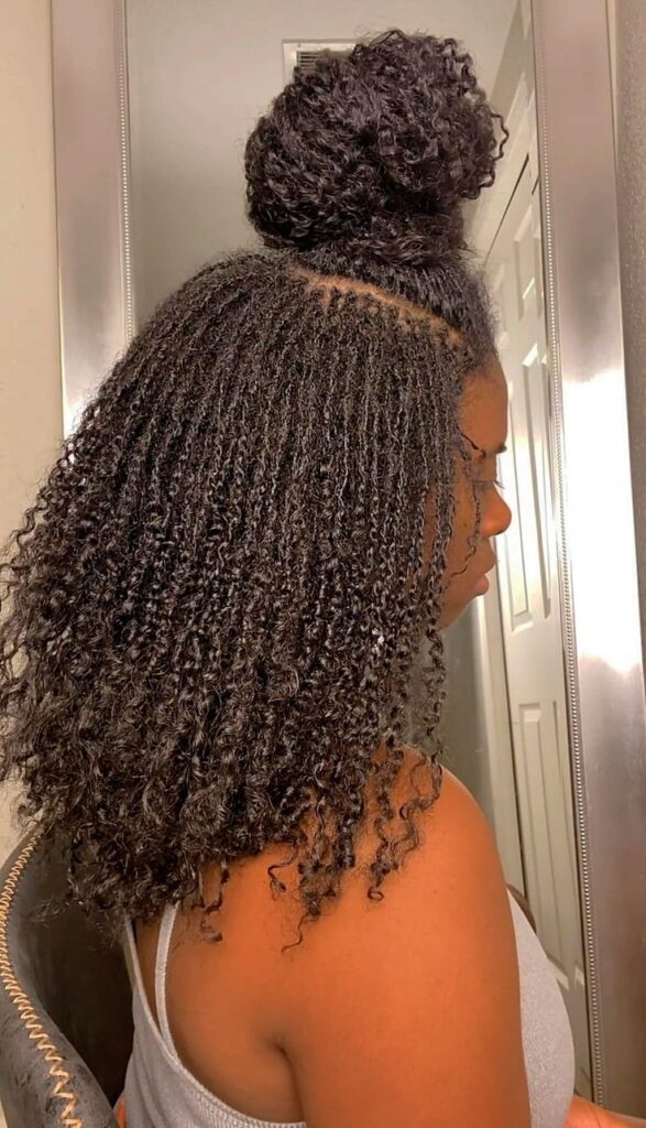 Sisterlocks with extensions packed in a half up, half down style