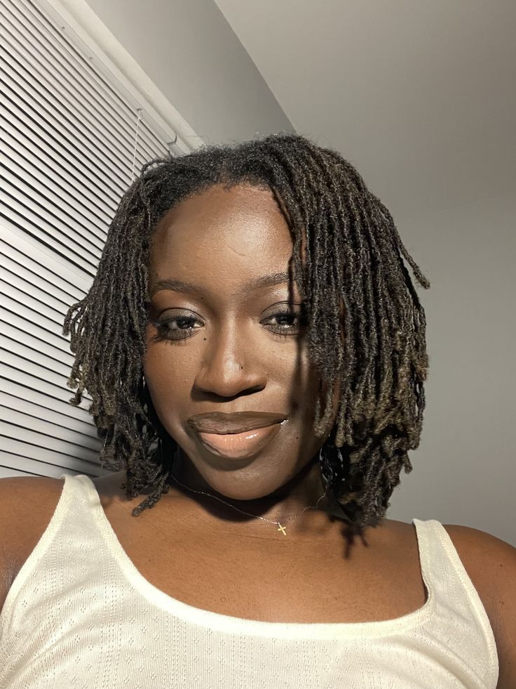 Woman on budding microlocs