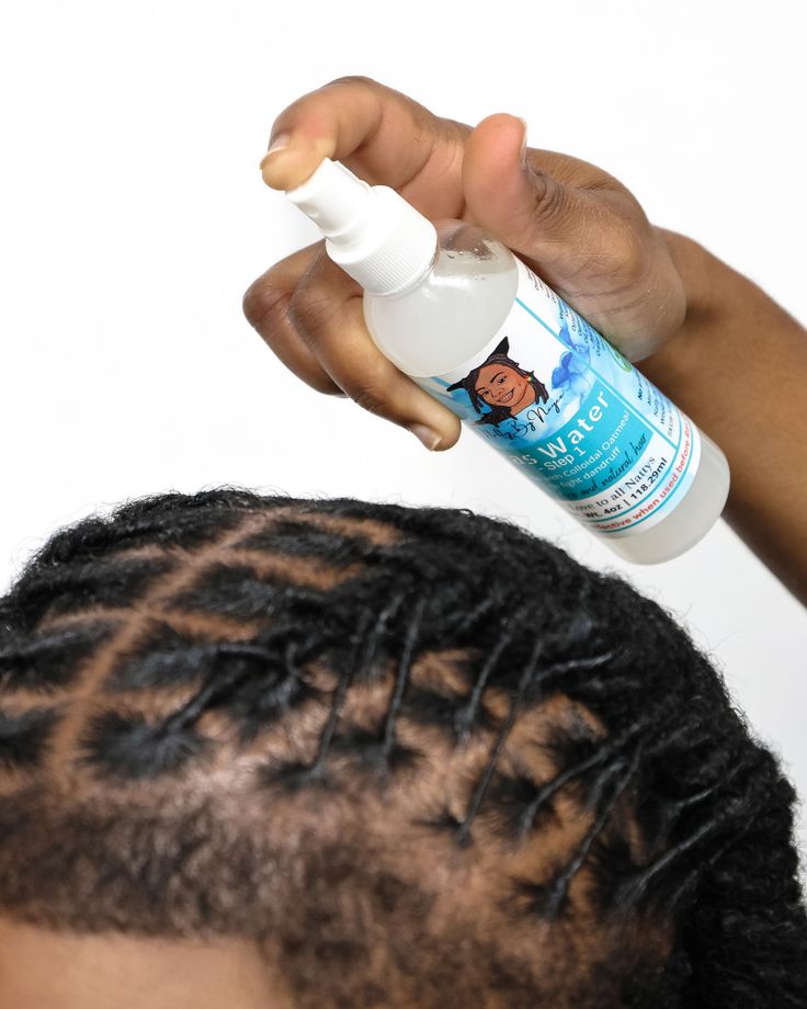 AN IMAGE OF A LOC HAIRSTYLE BEING MOISTURIZED 