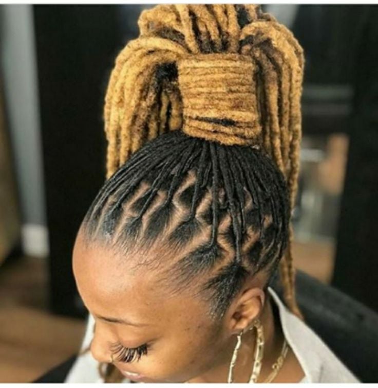 AN IMAGE OF A HIGH PONYTAIL PACKED LOCS WITH A BLACK ROOT AND GOLDEN MIDDLE TO TIP.