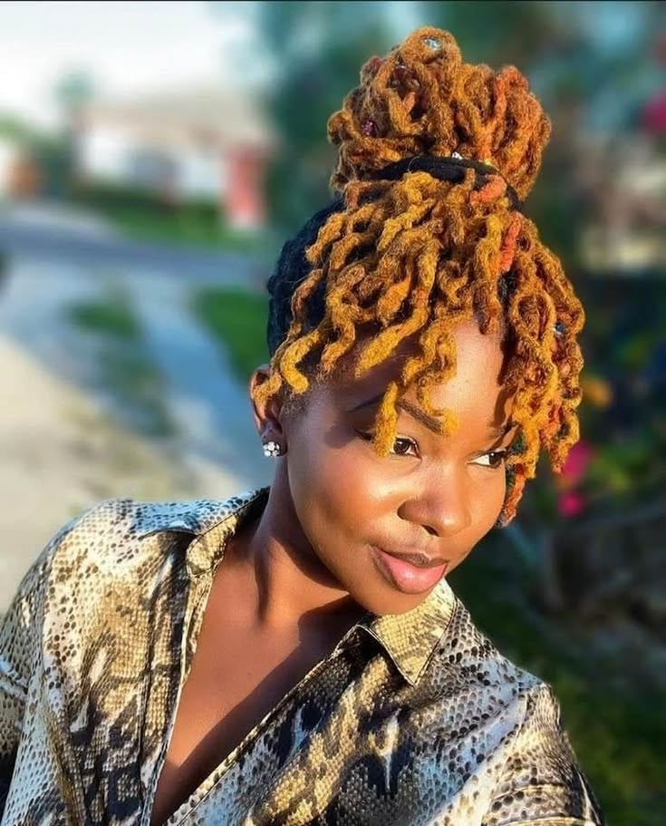 AN IMAGE OF A LADY ON GOLDEN BROWN MESSY BUN LOCS