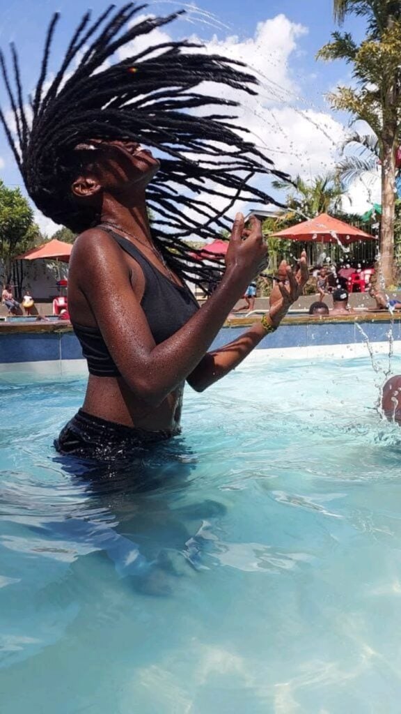 A LADY ON LOCS INSIDE A POOL
