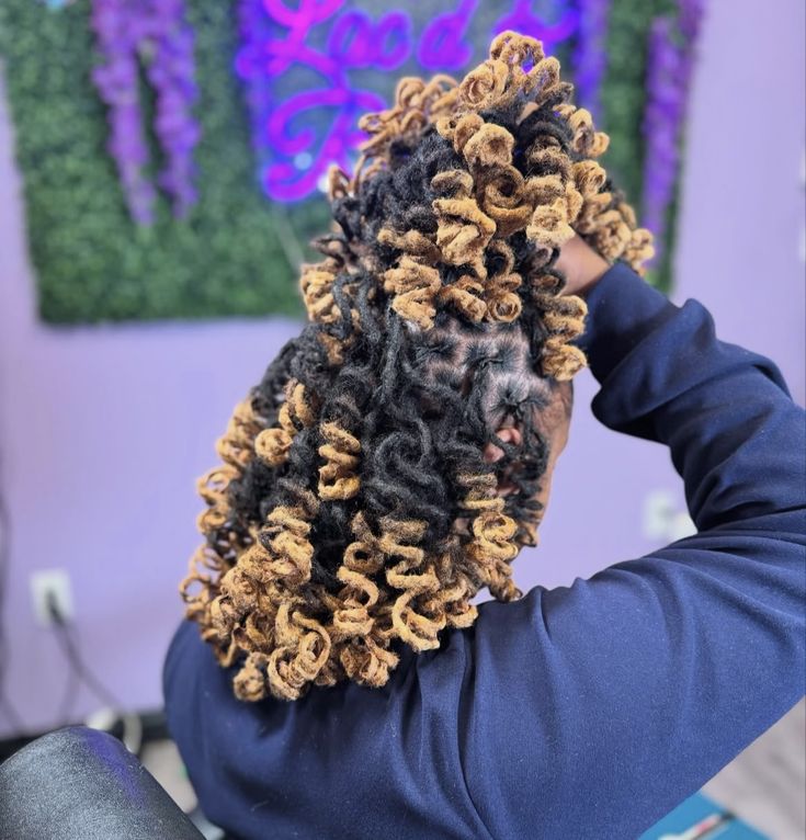 Half-up curled locs with soft face-framing pieces
