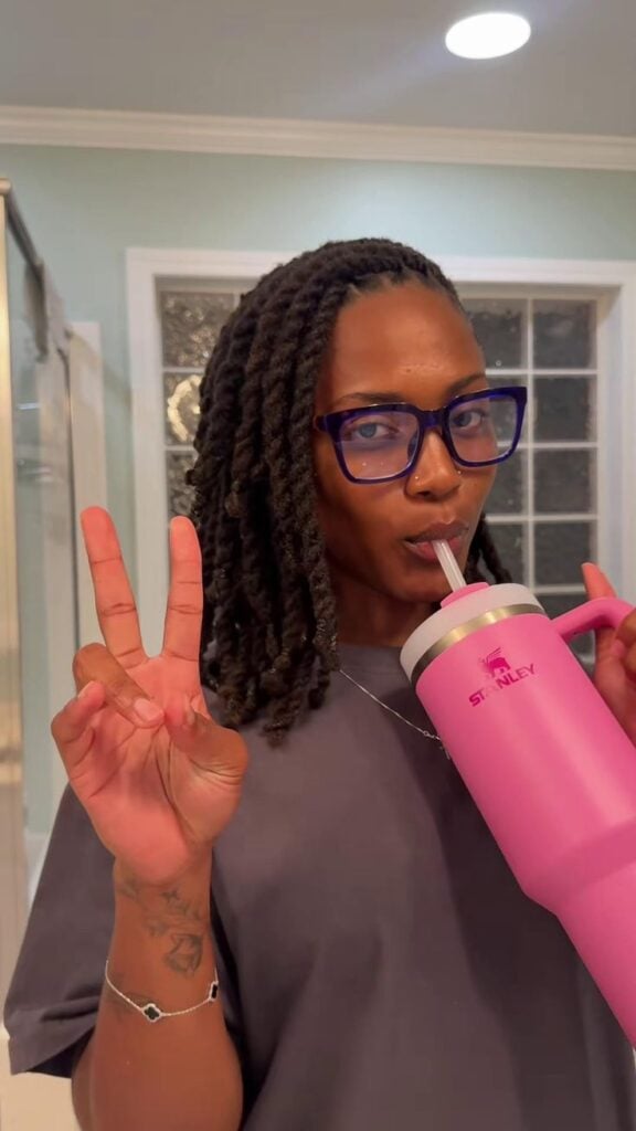 A LADY ON LOCS SIPPING WATER