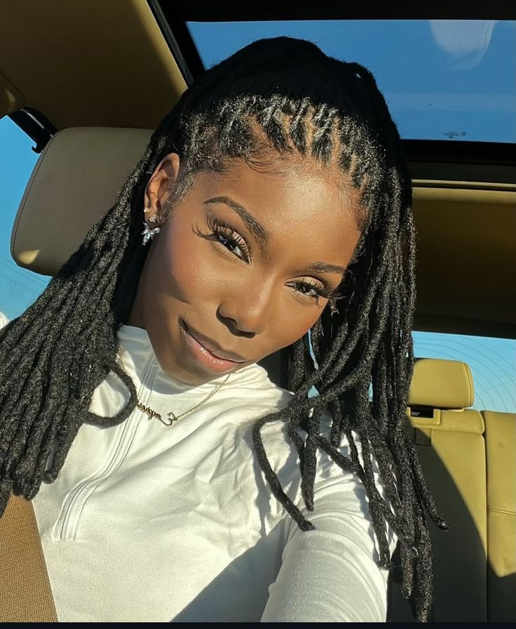 beautiful lady wearing locs inside a car